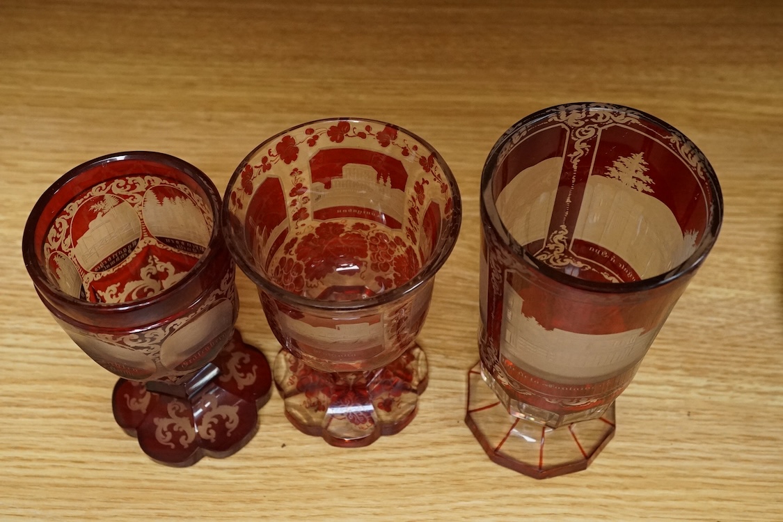 Three Bohemian topographical engraved ruby flashed spa glasses, late 19th century, largest 16cm high
